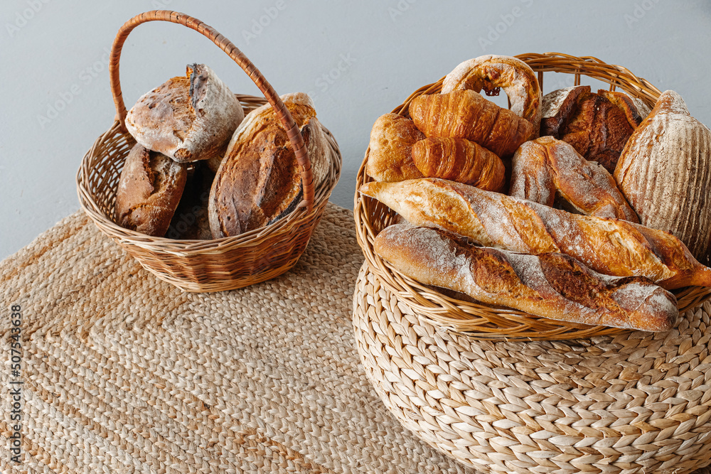Basket with a range of bread and pastries in a modern beautiful interior. Basket with a range of bread and pastries in a modern beautiful interior.
