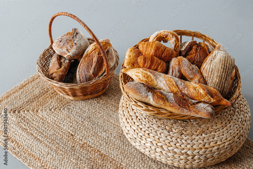 Basket with a range of bread and pastries in a modern beautiful interior.