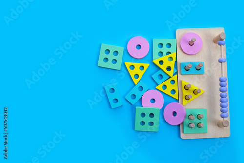 Colorful wooden domino toys for children on blue background.