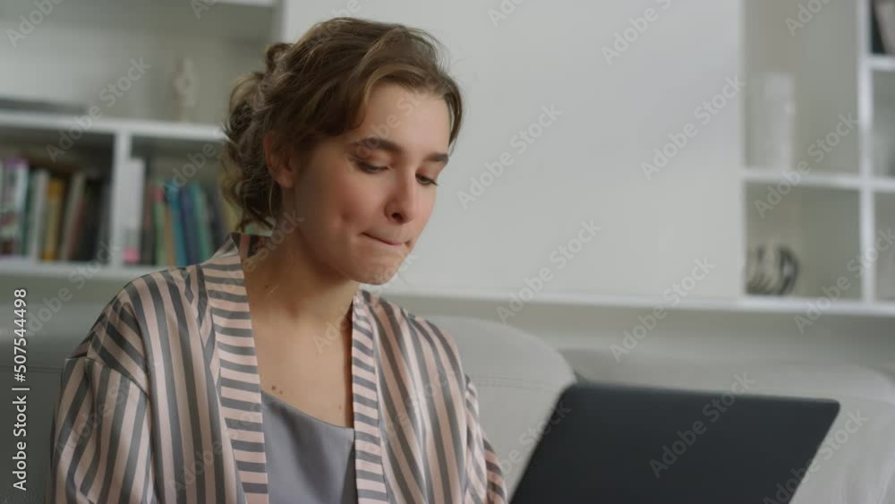 Thinking manager working home on laptop closeup. Cute lady in pajamas send email Thinking manager working home on laptop closeup. Cute lady in pajamas send email