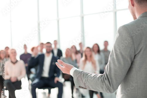 image of a speaker giving a lecture at a business seminar photo