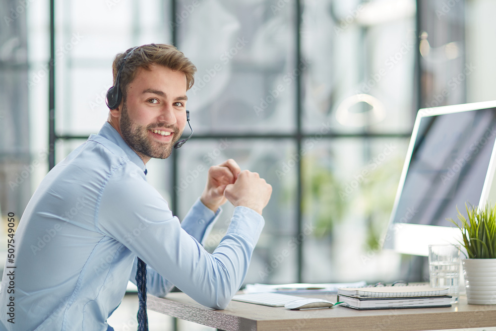 Fototapeta premium Man with headphones and laptop working in office