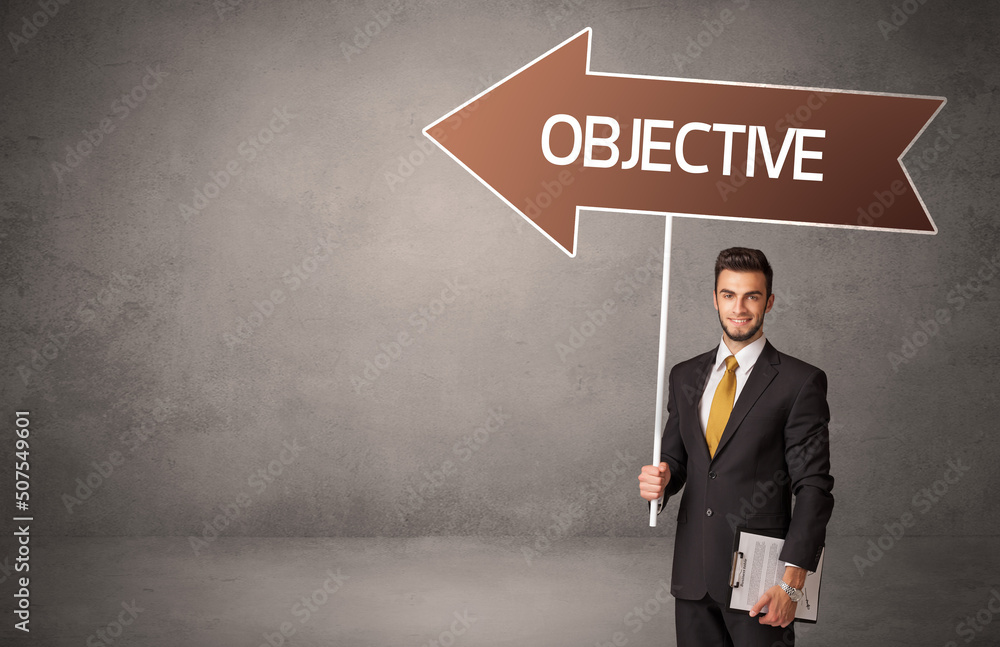 Fototapeta premium Young business person in casual holding road sign