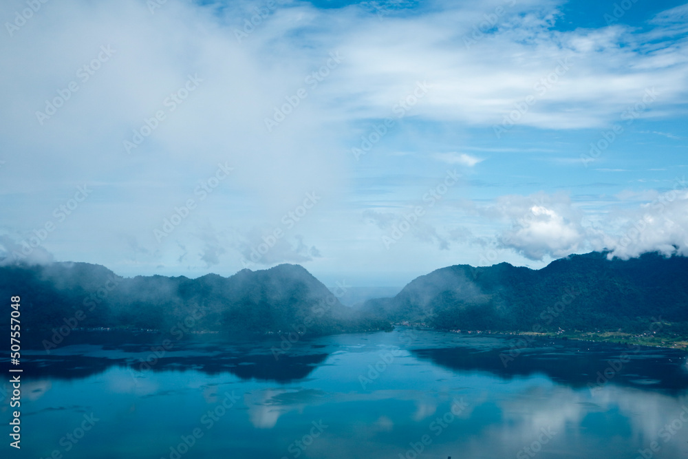 Danau Maninjau is an impressive volcanic lake at the bottom of an immense caldera measuring 20 kilometres by 8 kilometres and created about 50,000 years when a massive volcano erupted.
