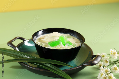 Buko Pandan or Buko Salad, Popular Dessert form Philipina. Made from Sliced ​​Young Coconut, Pearl, Jelly, Nata de Coco  with Sweetened Milk or Cream. photo