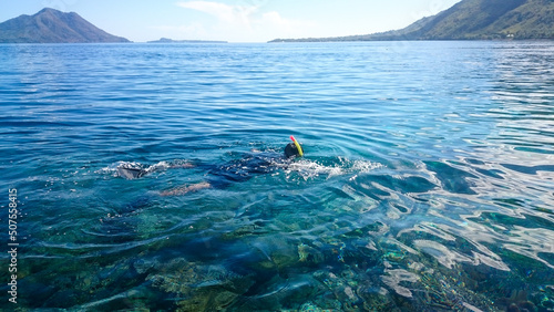 A man snorkeling in the ocean. Alor Island, Indonesia