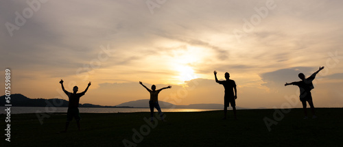 Silhouette of Happy Four People Travel at Countryside at Sunset During Summer Vacation