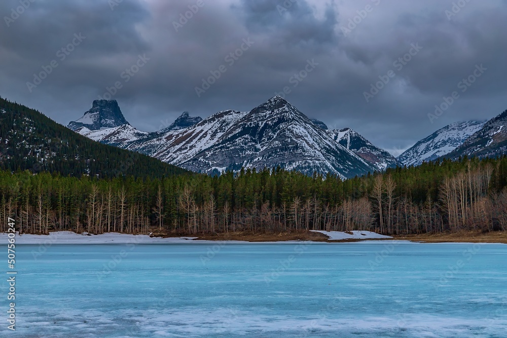Moody Clouds Over A Frozen Mountain Lake