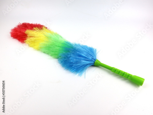 Soft colorful duster with a plastic handle on white background