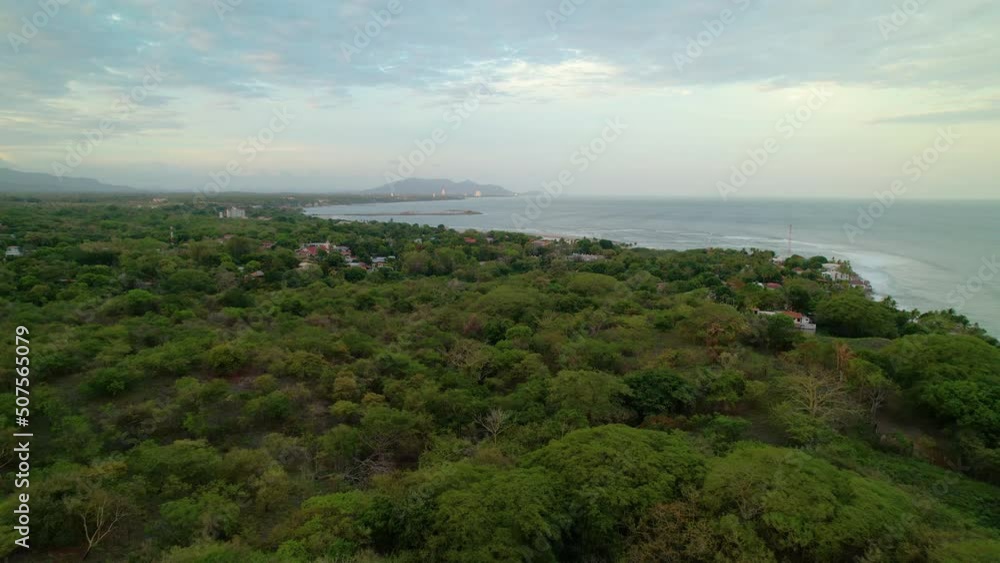AERIAL: Flying over the dense jungle and towards the paradise-like coast of El Palmar, Panama. Countless lush palm trees lead up to the endless blue ocean washing the picturesque beaches of Panama. AERIAL: Flying over the dense jungle and towards the paradise-like coast of El Palmar, Panama. Countless lush palm trees lead up to the endless blue ocean washing the picturesque beaches of Panama.