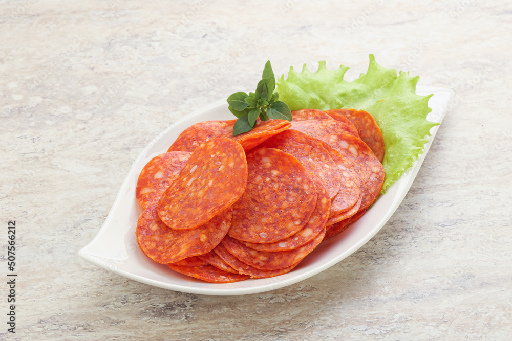 Sliced pepperoni sausage in the bowl Sliced pepperoni sausage in the bowl