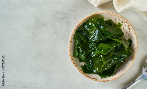 Obraz na plátně top view or flat lay laminaria (Kelp) seaweed in a bowl on white background with