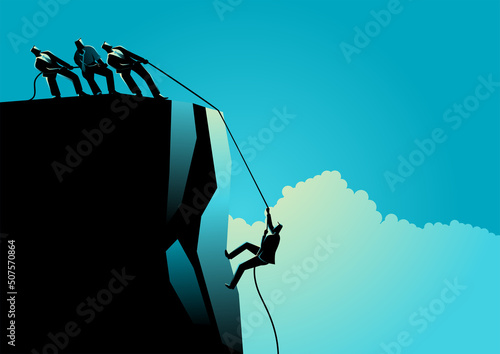 Businessmen helping their friend climbing the rock