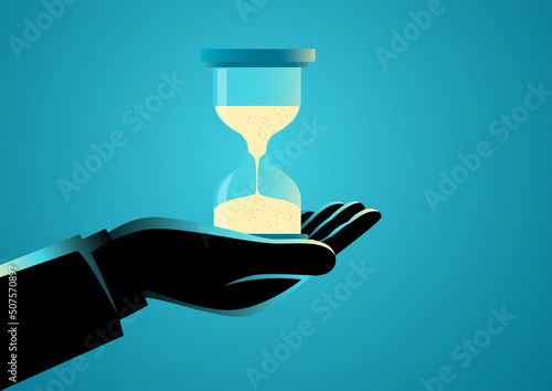 Hand holding a sand glass