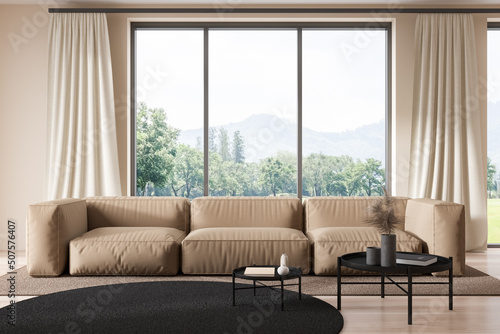 Light living room interior with sofa and coffee table, panoramic window © ImageFlow