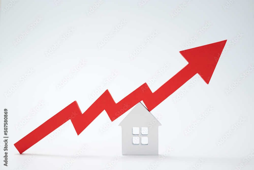 a red up arrow and house. The concept of the rising price of real estate a red up arrow and house. The concept of the rising price of real estate