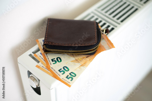 Wallpaper Mural Heating. Wallet with money euro on the heating radiator. Payment for services. Energy. Utility bill Torontodigital.ca