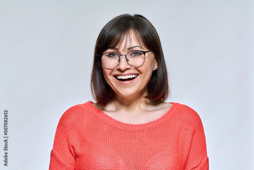 Headshot of smiling middle aged woman looking at camera