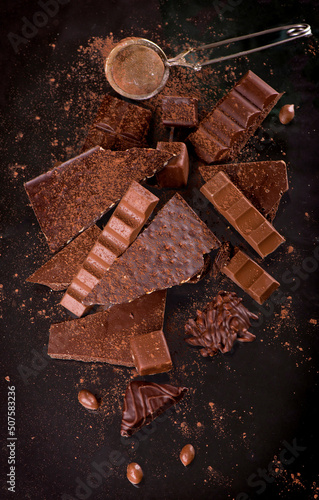 dark chocolate over wooden background, selective focus