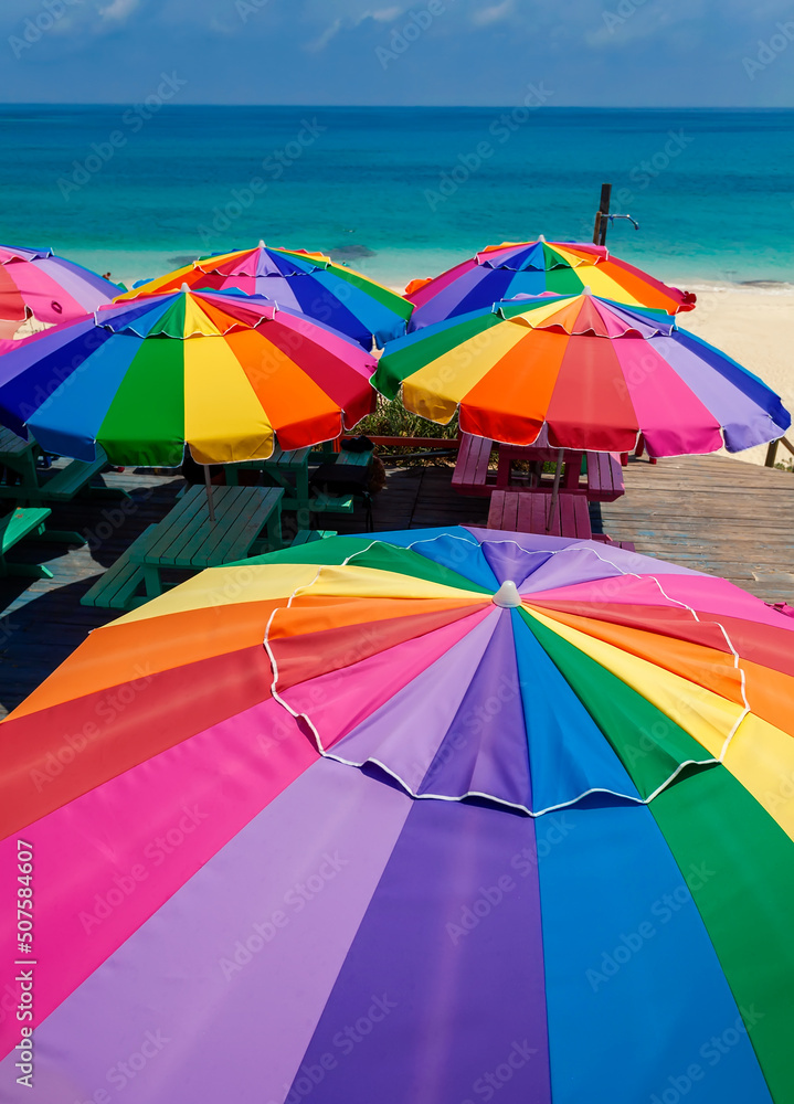 Colorful beach umbrellas in the tropical sunshine Caribbean