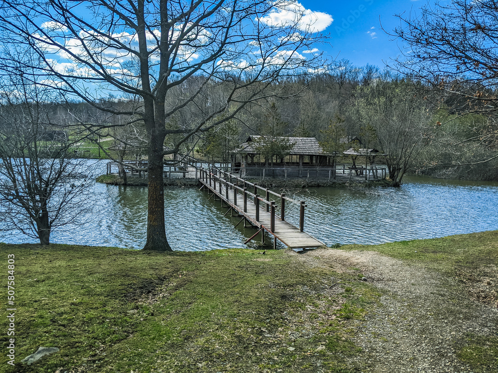 lake with gazebos and green grass