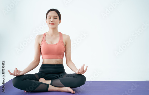 Woman Asian group beautiful Young Yoga sports woman doing exercises and doing yoga fitness,Short Meditation,sport and healthy lifestyle. people stay at home healthy concept.