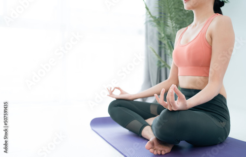 Asian female beautiful Young Yoga sports woman doing exercises and doing yoga fitness,Short Meditation,sport and healthy lifestyle. people stay at home healthy concept.