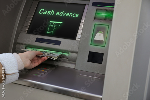 Woman using cash machine for money withdrawal, closeup