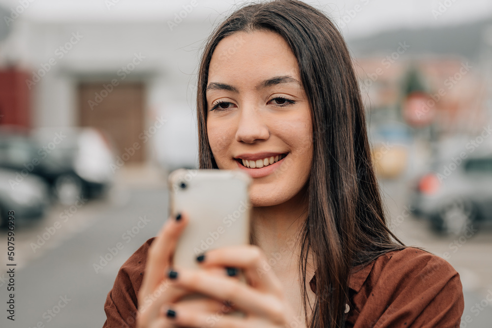 girl on the street looking at the mobile phone girl on the street looking at the mobile phone