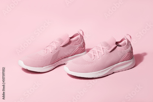 Pink pastel color sneakers on background