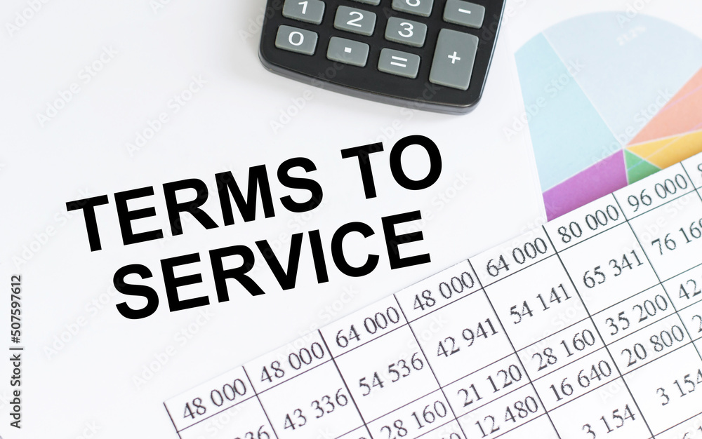 Terms Of Service text on notepad next to calculator, reports Terms Of Service text on notepad next to calculator, reports