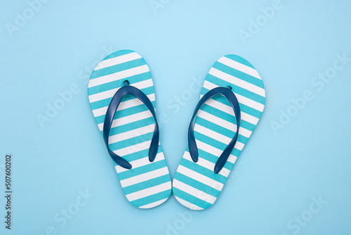 children's beach flip-flops on a blue background
