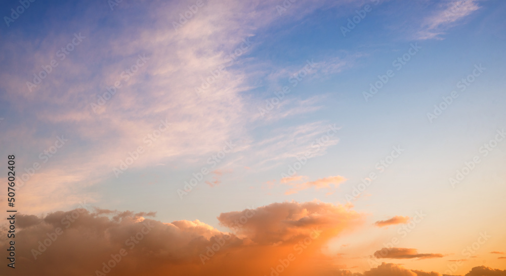 beautiful sunset sky scenery with gradient colors from orange to blue, with clouds