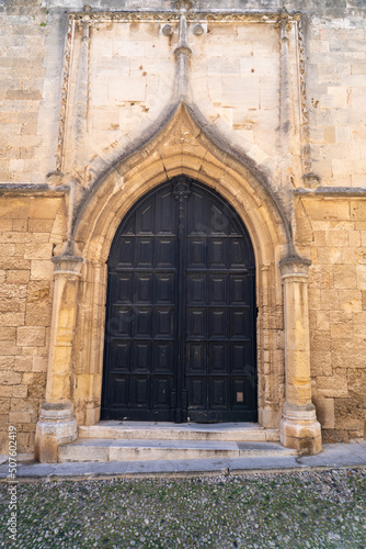 Antique  arch door and stone wall in day light. © omar