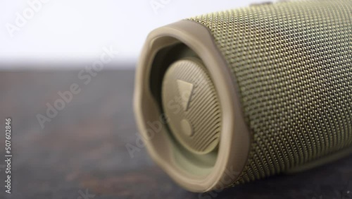 Ukraine, Dnipropetrovsk 03.11.2021 JBL Portable Bluetooth Speaker. The speaker membrane in the sound column while playing music. Close-up footage of portable speaker. photo