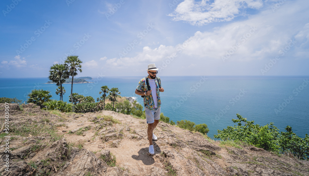 Young traveler man at summer holiday vacation with beautiful mountains and seascapes at background