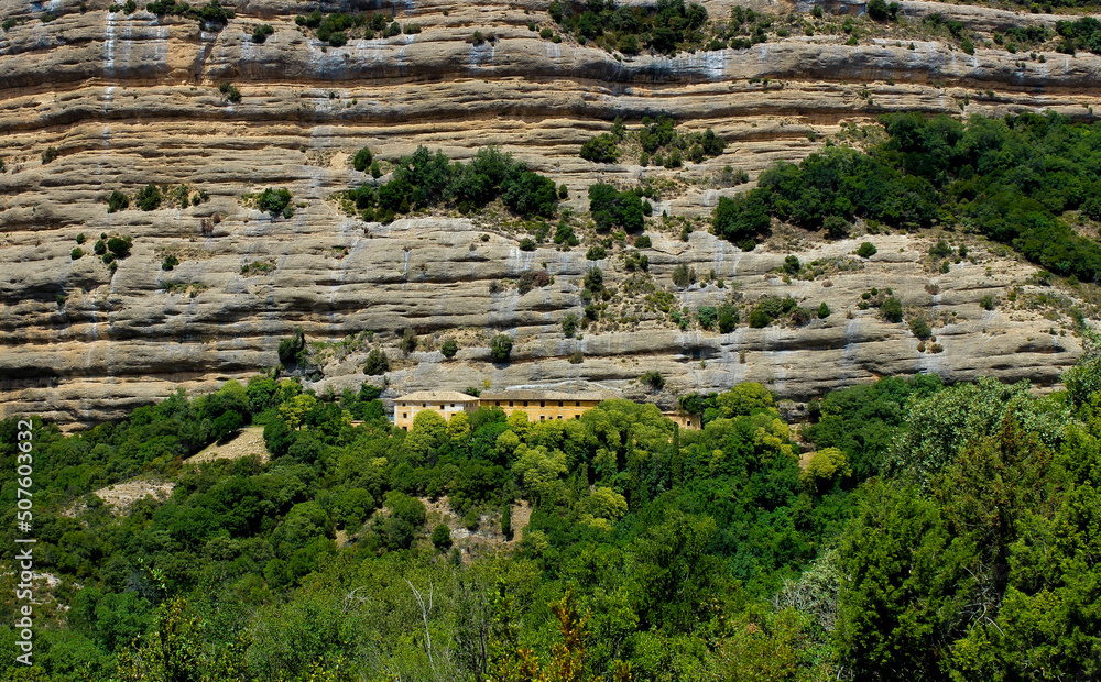 Monastery between rock cliffs in wild nature in Spain