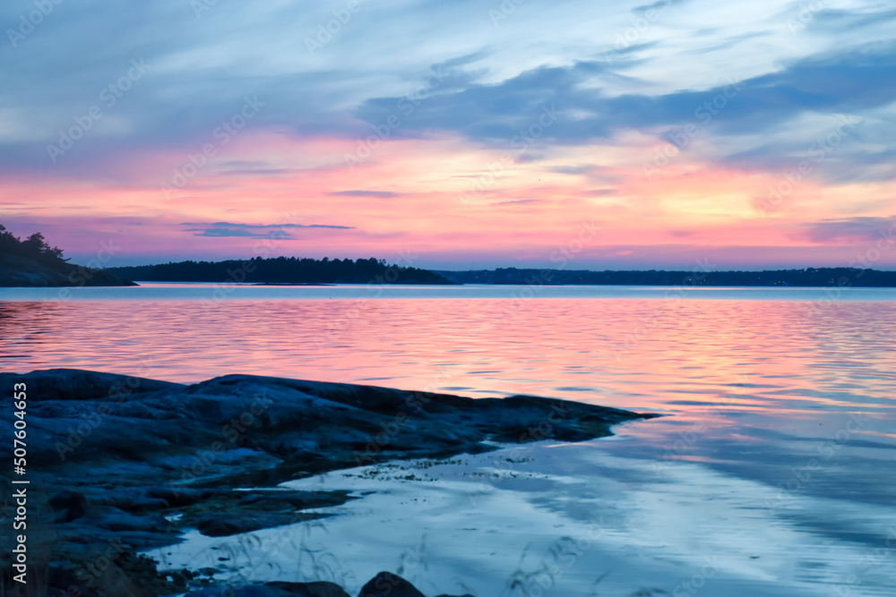 Blue pink romantic sunset over a lake in Sweden
