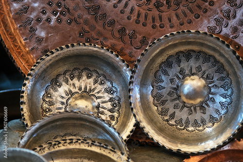 Traditional handmade patterned metal souvenir plates in Gaziantep, Turkey photo