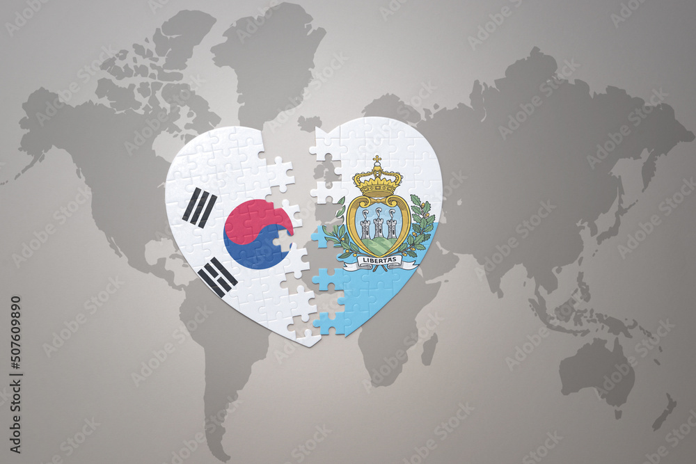 puzzle heart with the national flag of san marino and south korea on a world map background. Concept. puzzle heart with the national flag of san marino and south korea on a world map background. Concept.