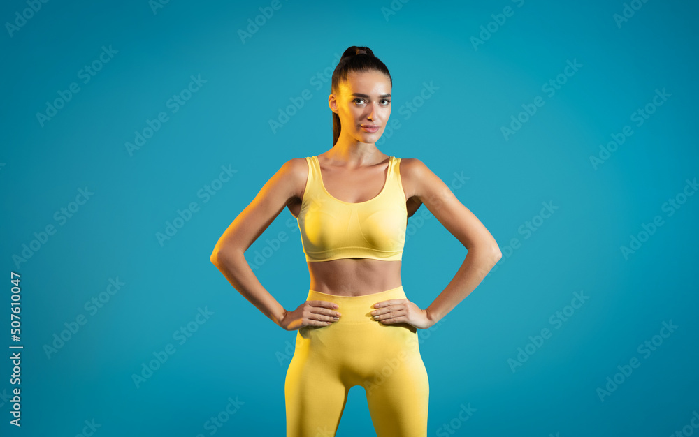 Fit Woman Wearing Sportswear Posing Standing On Blue Background Fit Woman Wearing Sportswear Posing Standing On Blue Background