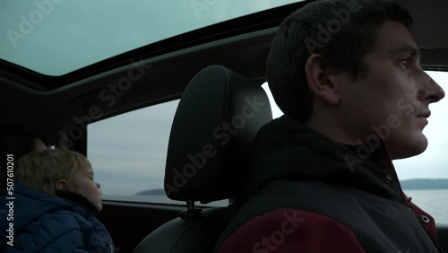 Wallpaper Mural Male Driver Drive Car on River Dam Along Reservoir.  Man with Family Travel by SUV Vehicle. Overcast Cloudy Sky. Autumn Winter Season. 2x Slow motion 60fps 4K Torontodigital.ca