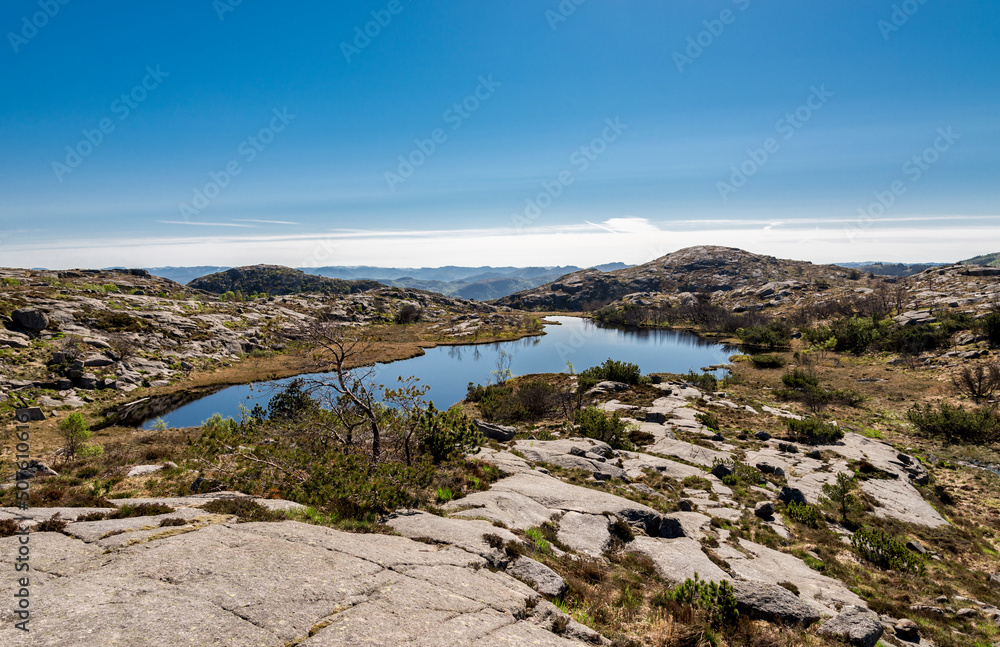 A view to a small scenic lake from Lifjel summit in a beautiful sunny day, Sandnes, Norway, May 2018