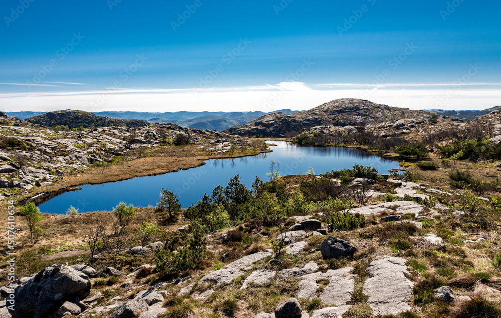 A small scenic lake next to Lifjel summit in a beautiful sunny day, Sandnes, Norway, May 2018