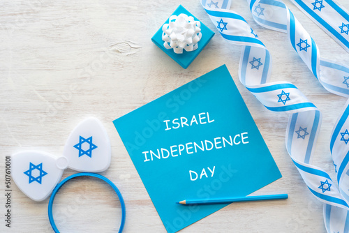 Greeting cards for Independence Day of Israel, Israeli symbols and items with national colors on white wooden background with copy space.