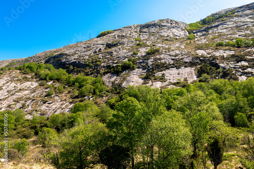 Obraz na płótnie A view from the base of the mountain on a coast to Lifjel steep slope and summit peak, Sandnes, Norway, May 2018 w salonie
