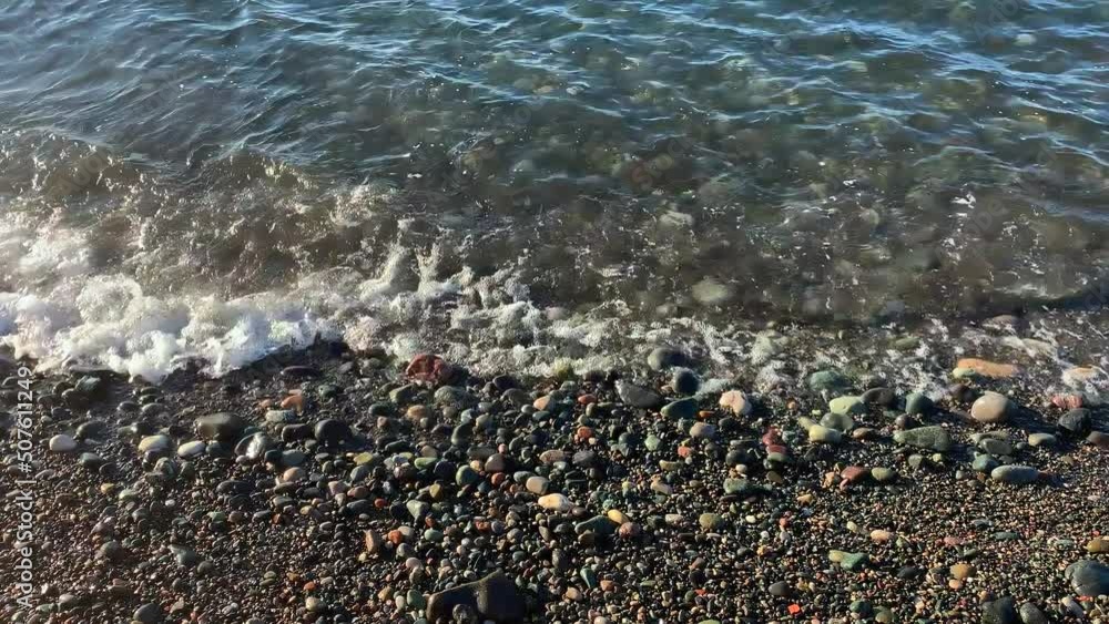 Coast of stones. Tide waves. Sea beach gray day. Wind Nature without man. Marine background place for text. Close up of water waves. Volumetric white clouds in sky. Beach for relax in winter autumn. Coast of stones. Tide waves. Sea beach gray day. Wind Nature without man. Marine background place for text. Close up of water waves. Volumetric white clouds in sky. Beach for relax in winter autumn.