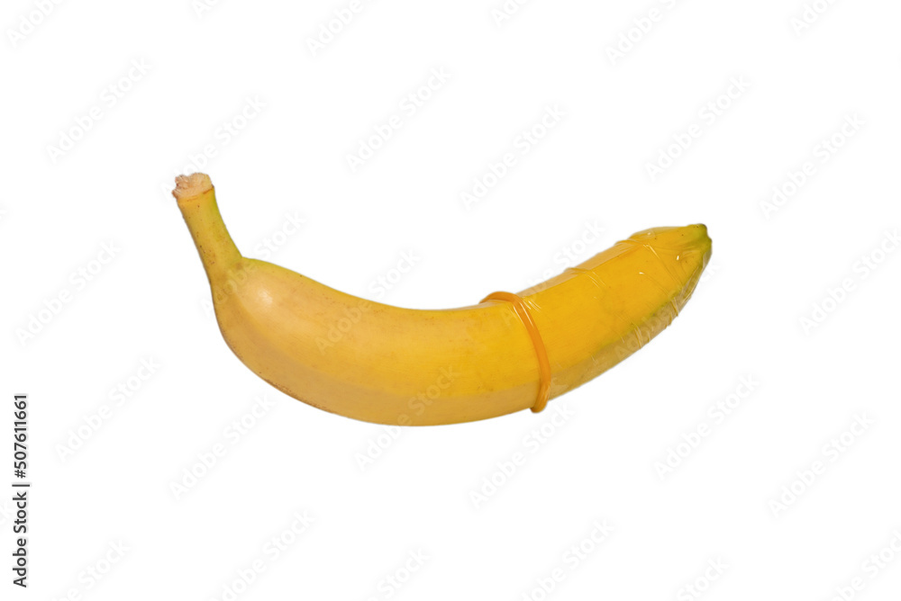 A banana with a condom on it isolated on white background. A banana with a condom on it isolated on white background.