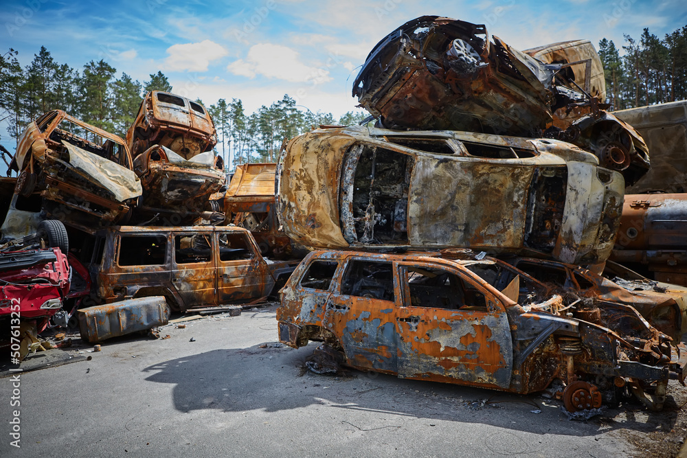 A lot of rusty burnt cars in Irpen, after being shot by the Russian military. Russia's war against Ukraine. Cemetery of destroyed cars of civilians who tried to evacuate from the war zone A lot of rusty burnt cars in Irpen, after being shot by the Russian military. Russia's war against Ukraine. Cemetery of destroyed cars of civilians who tried to evacuate from the war zone