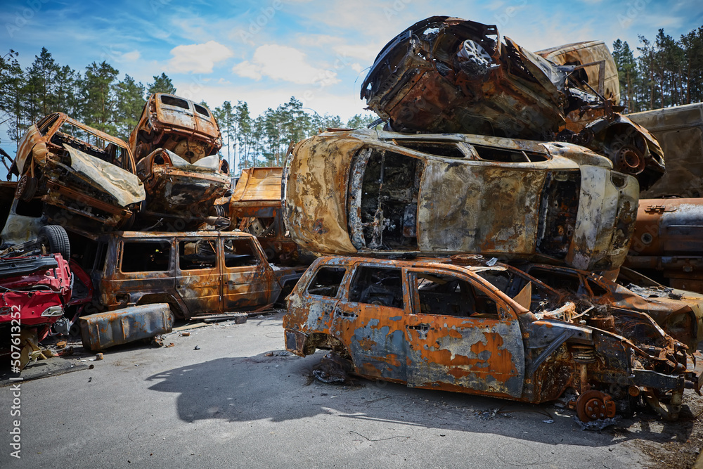 A lot of rusty burnt cars in Irpen, after being shot by the Russian military. Russia's war against Ukraine. Cemetery of destroyed cars of civilians who tried to evacuate from the war zone